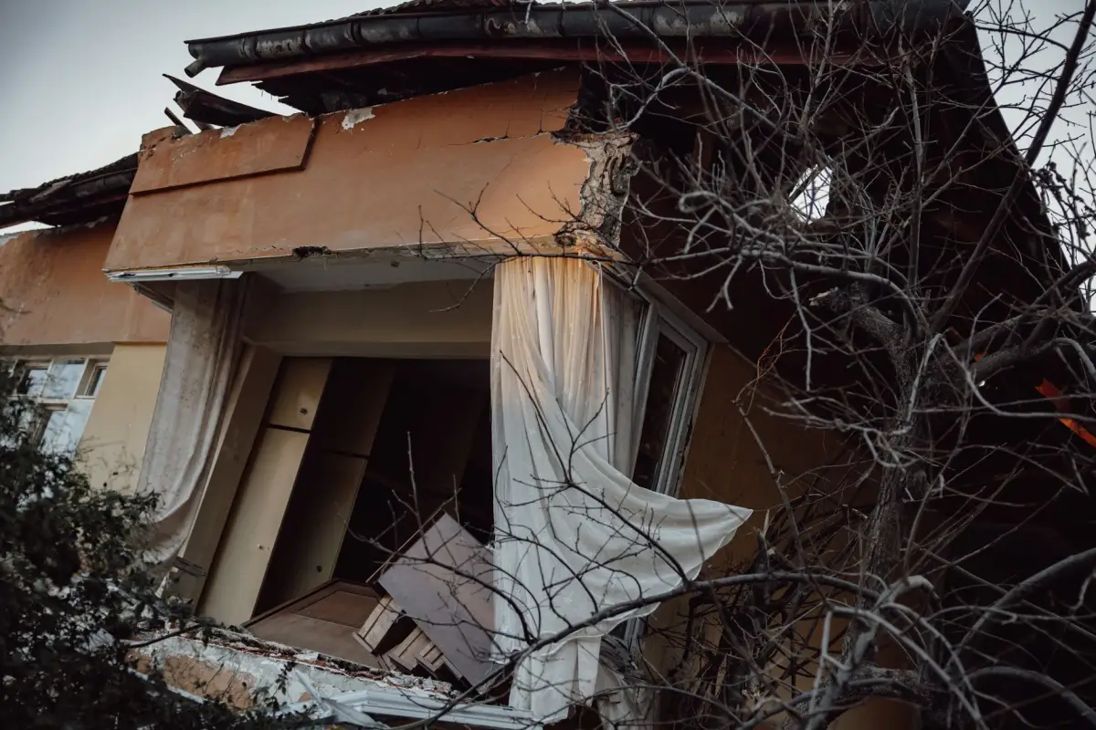 The exterior of a building showing structural damage after a storm