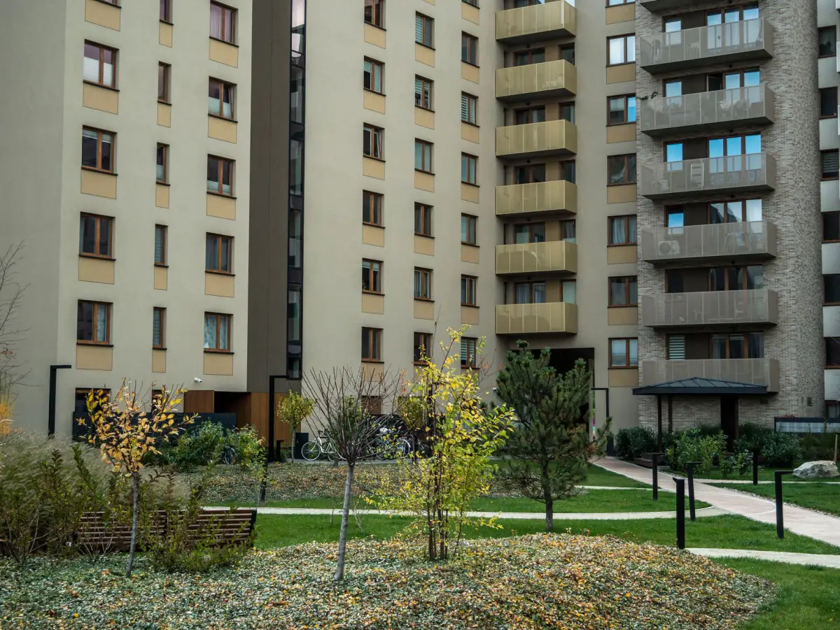 Landscaped pathways and mature trees in a multi-family common area